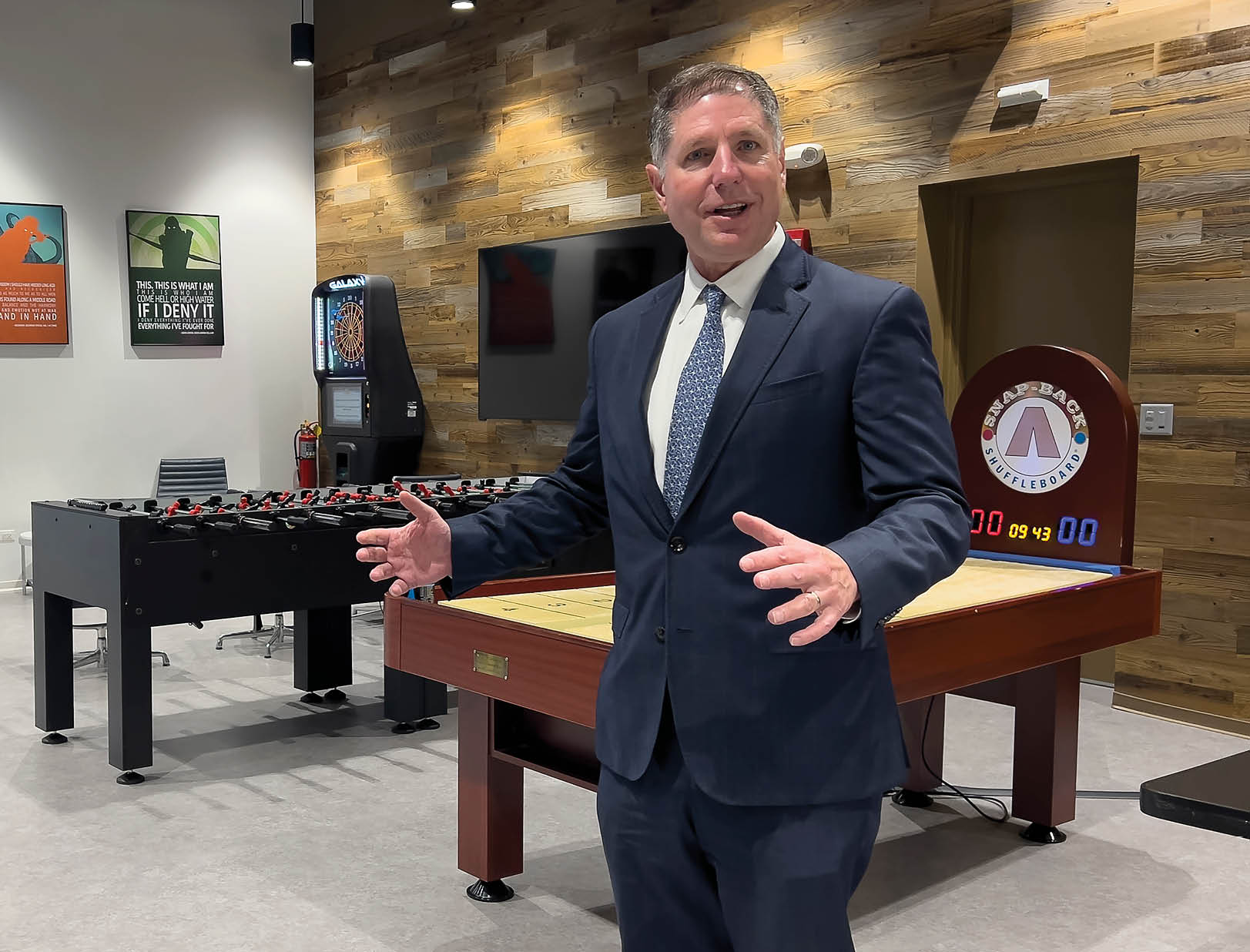 Mark Welsh/mwelsh@dailyherald.com Mark Hamiliton company owner of Hamiliton Lakes Business Park in Itasca shows off their new work space game room area. 