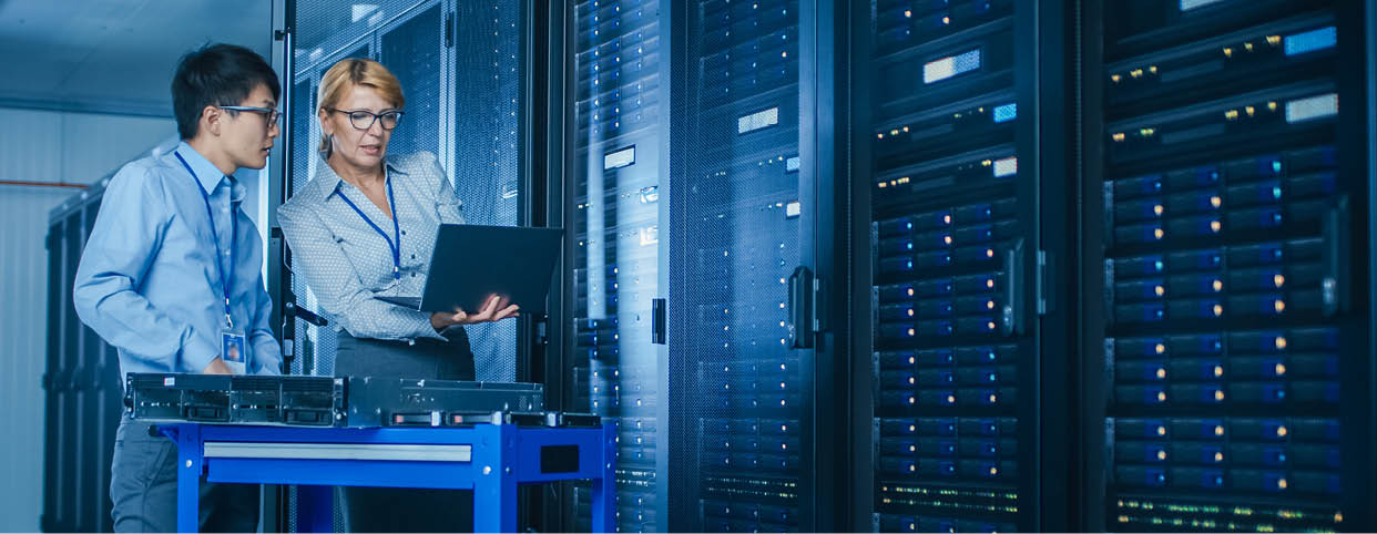 In the Modern Data Center: Engineer and IT Specialist Work with Server Racks, on a Pushcart Equipment for Installing New Hardware. Specialists Doing Maintenance and Diagnostics of the Database.