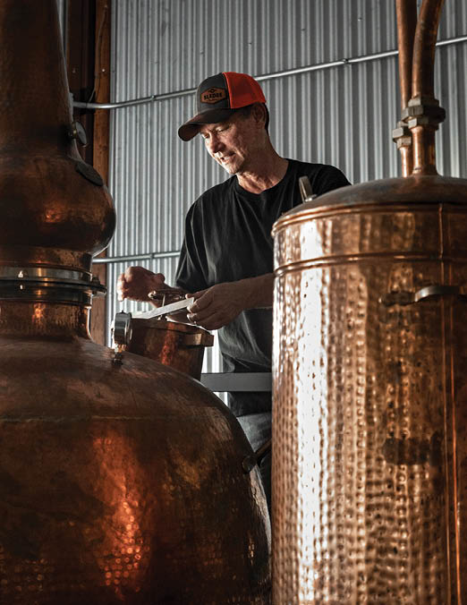 Sledge Distillery - Tolar, TX. Mark Sledge works the copper still
