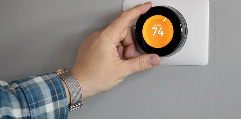 Man is Adjusting a temperature in modern living room