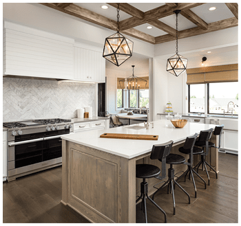 Kitchen Interior with Island, Sink, Cabinets, and Hardwood Floors in New Luxury Home. Includes elegant pendant light fixtures and wood beam ceiling