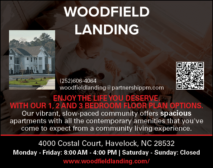 A man and a child are shown in a living room, with a bed in the background. The advertisement is for Woodfield Landing apartments, with a phone number and website listed. AI generated content