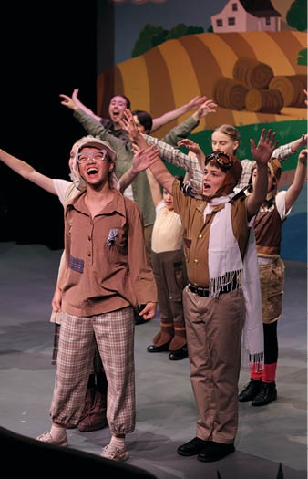 A group of children are on stage performing. Description generated by AI