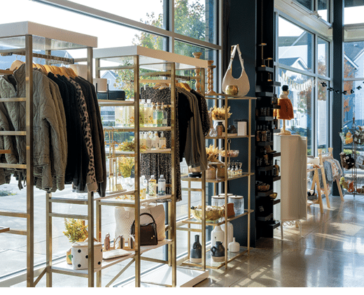 A store with a lot of clothing and accessories. Description generated by AI