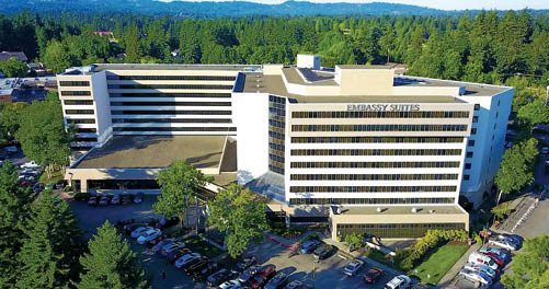 A large white building with many windows. Description generated by AI