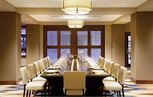 A long table with chairs and a centerpiece. Description generated by AI