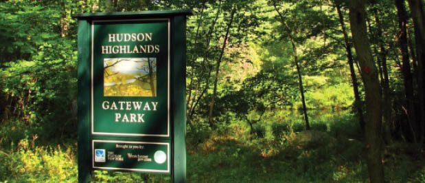 A sign in the woods Description automatically generated with medium confidence