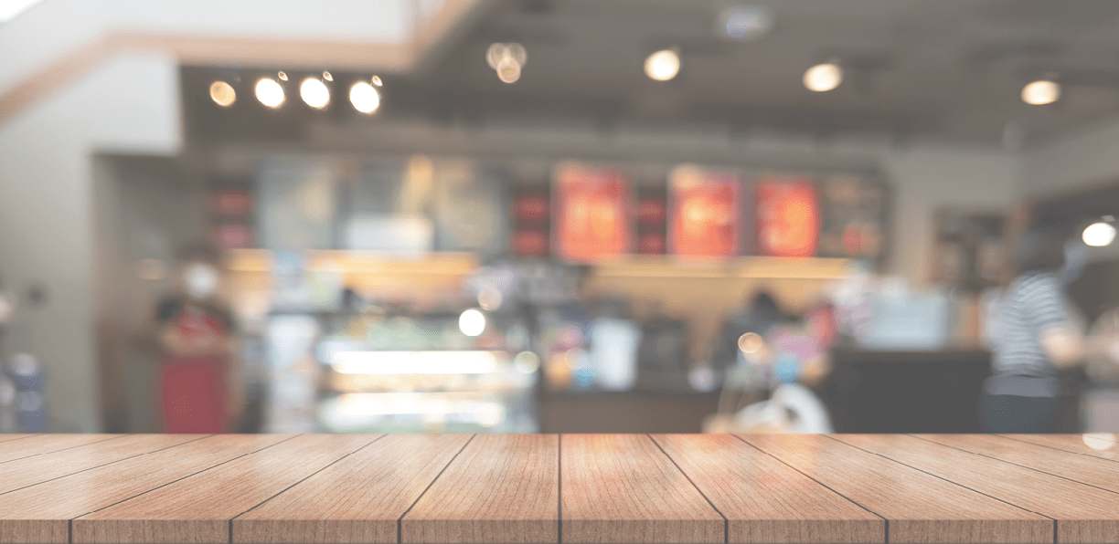 Empty wooden table top with lights bokeh on blur restaurant background