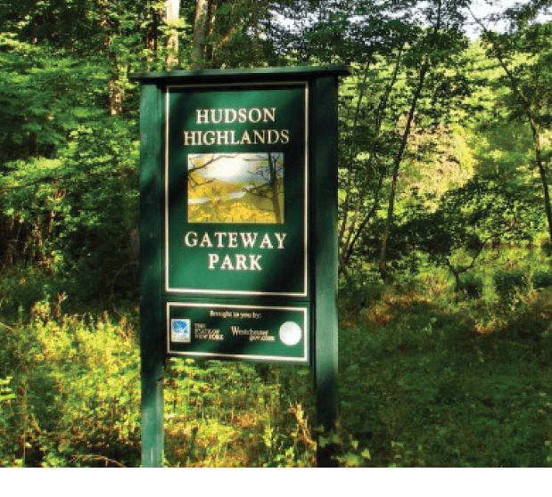 A sign in the woods Description automatically generated with medium confidence