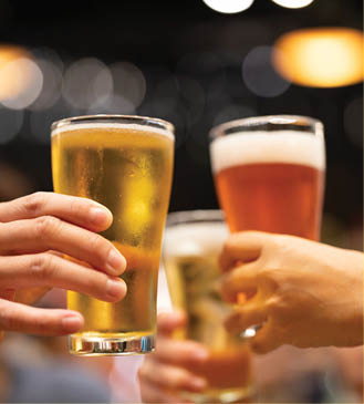 Group of happy friends drinking and toasting beer at brewery bar restaurant - Friendship concept with young people having fun together