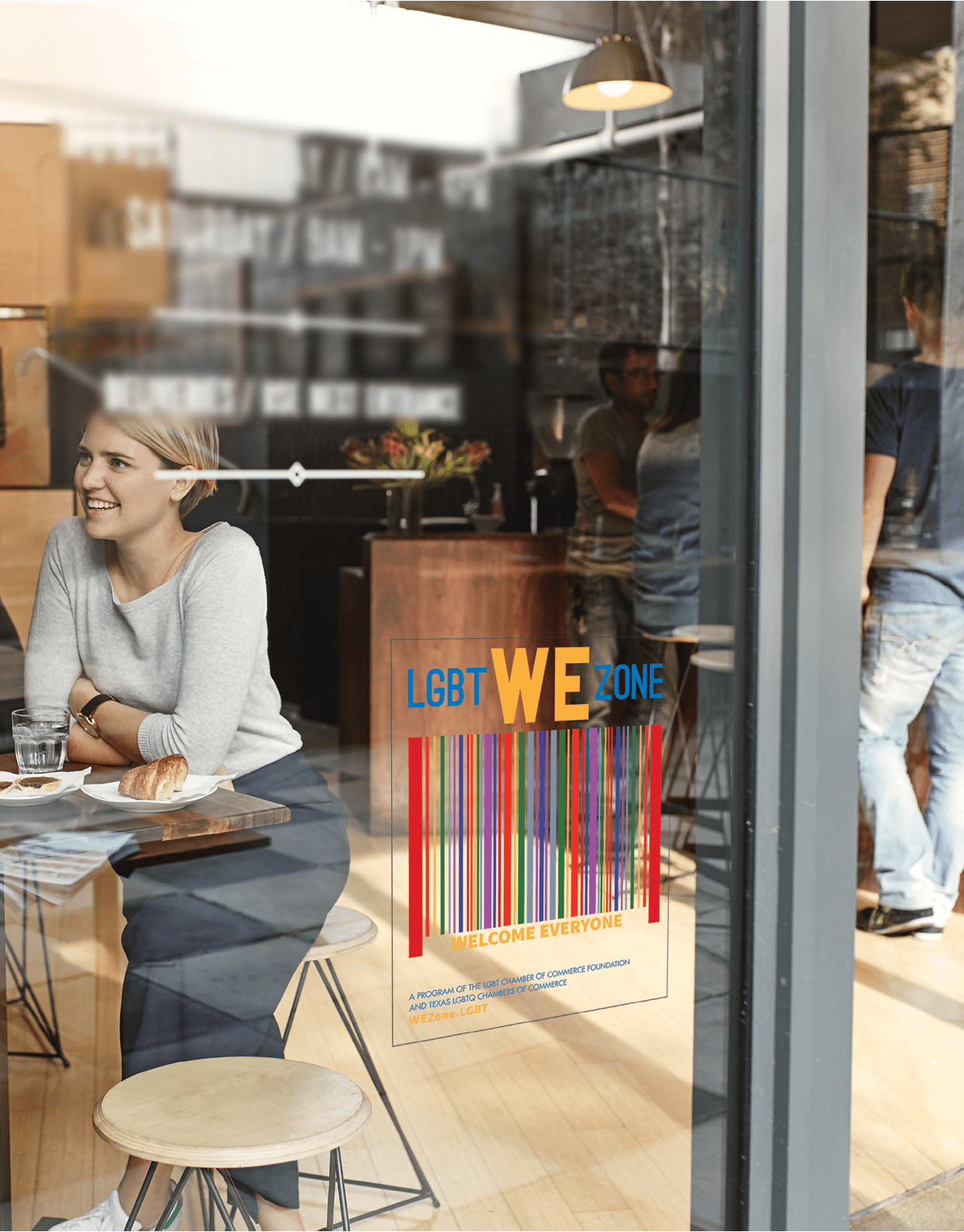 Woman with friends at a cafe seen through window