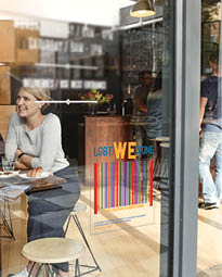 Woman with friends at a cafe seen through window