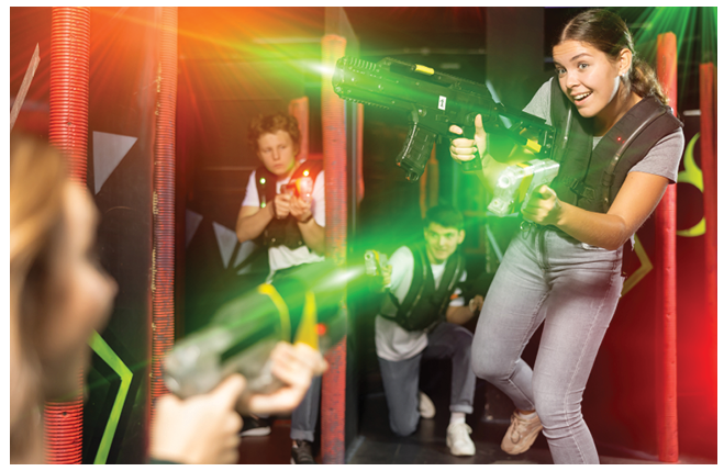 Young woman playing lasertag in arena