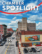 A magazine cover featuring a city street with a red car and a bicycle. AI generated content