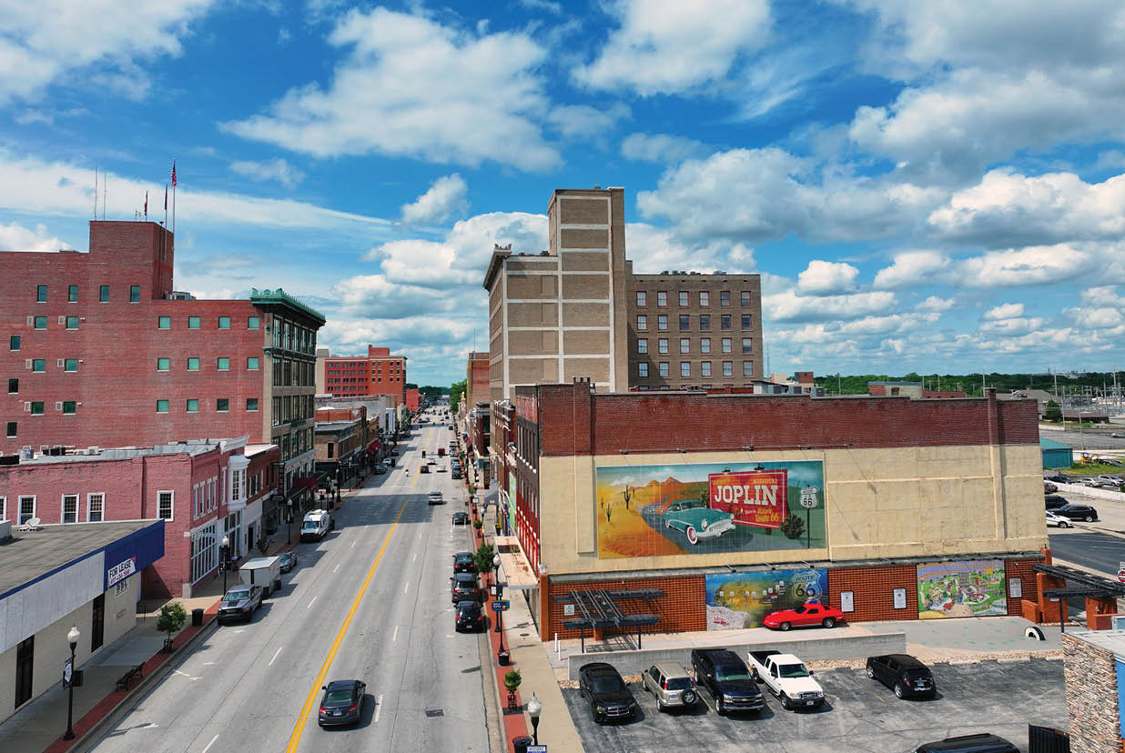 A city street with tall buildings, cars, and pedestrians. AI generated content