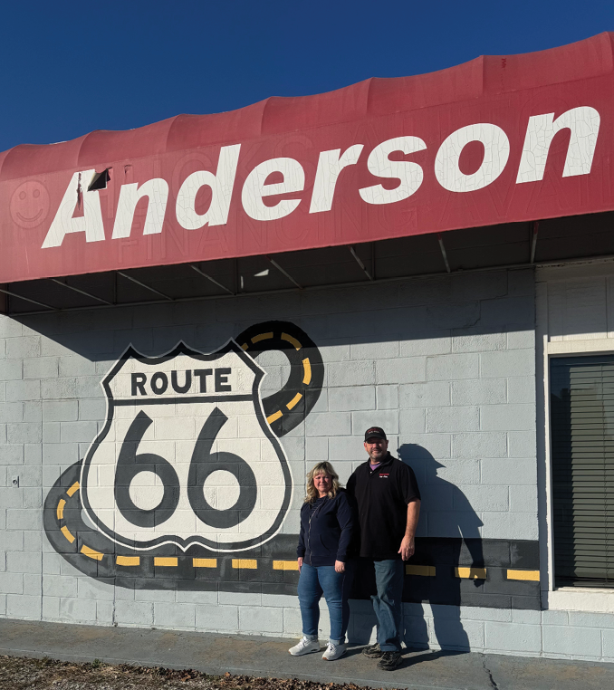 A man and woman are standing in front of a Route 66 sign. AI generated content