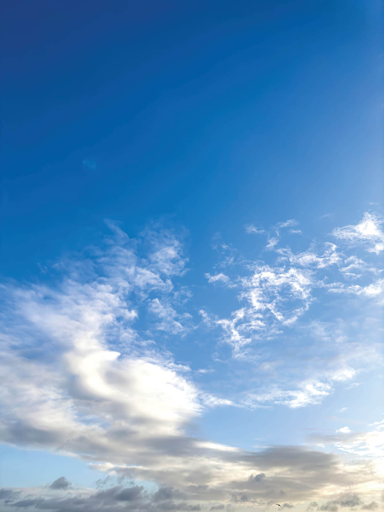 Beautiful blue sky in sunny weather with white clouds.