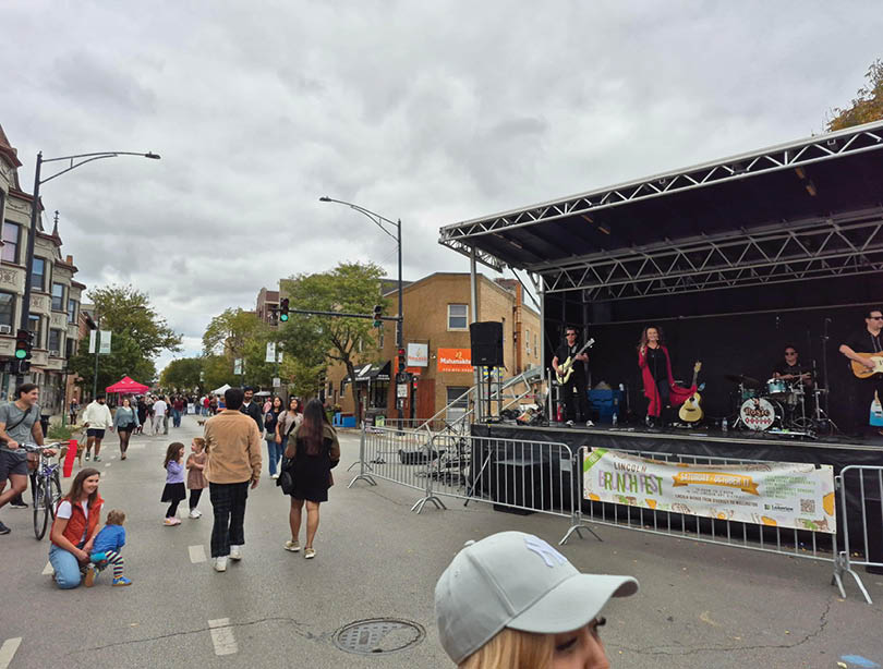 A group of people are walking down a street. Description generated by AI