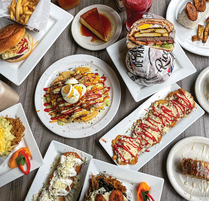 A table with plates of food and drinks. Description generated by AI