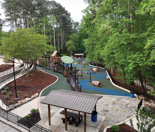 A playground with a wooden structure and a green roof. Description generated by AI