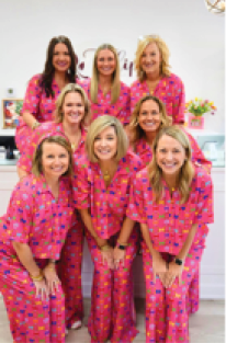 A group of women in colorful dresses. Description generated by AI