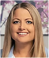 A woman wearing a blue shirt and white blouse. Description generated by AI