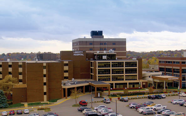 A large building with a parking lot in front of it. Description generated by AI