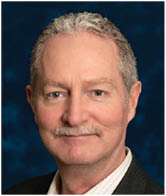 A man wearing a suit and tie. Description generated by AI