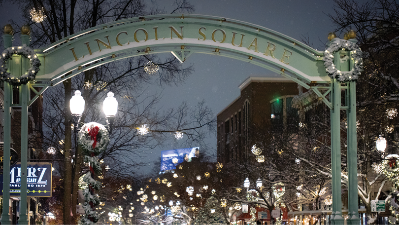 A large archway with a sign that reads “Lincoln Square." Description generated by AI