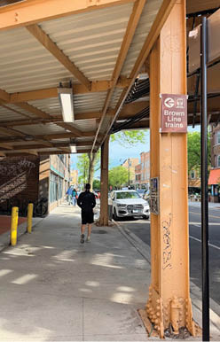 A man is walking on a sidewalk. Description generated by AI