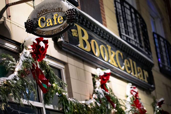 A sign for a cafe with a snowman on it. Description generated by AI