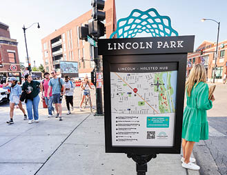 A map of Lincoln Park is displayed on a black sign. Description generated by AI