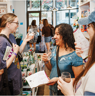 A group of women are standing in a book store. Description generated by AI