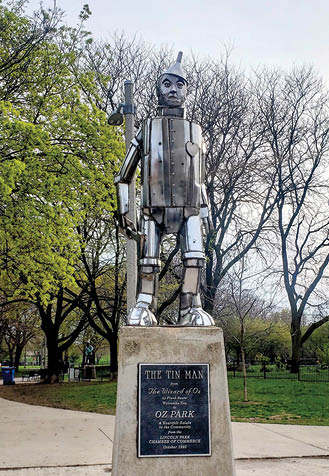 A statue of a man in a suit is on a pedestal. Description generated by AI
