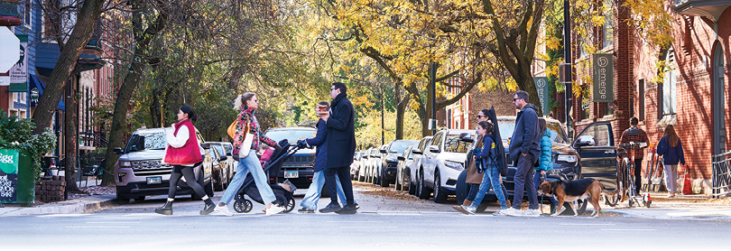 A group of people crossing a street. Description generated by AI