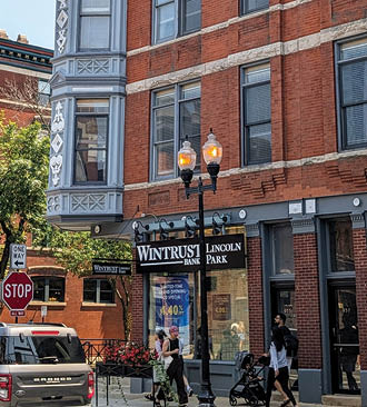 A tall brick building with a sign that says “Vintage". Description generated by AI