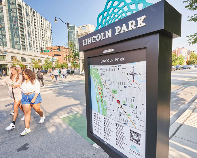 A black and white sign with a map of Lincoln Park. Description generated by AI