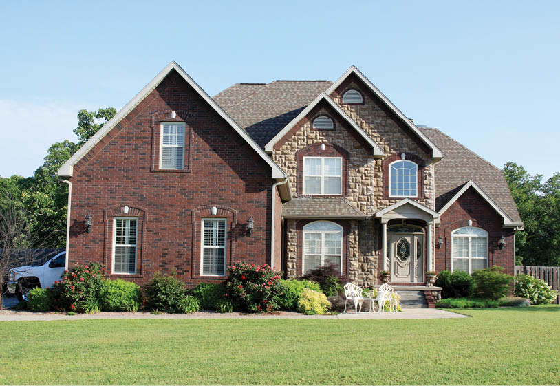 A beautiful luxury home on an acreage is photographed.