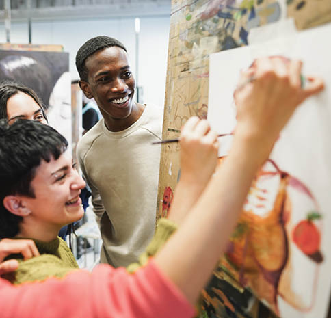 Multiracial students painting inside art room class at university - Focus on african man face
