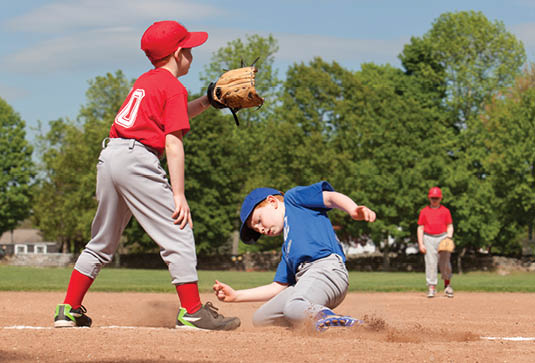 Boy sliding into base during a baseball game with Instagram style filter