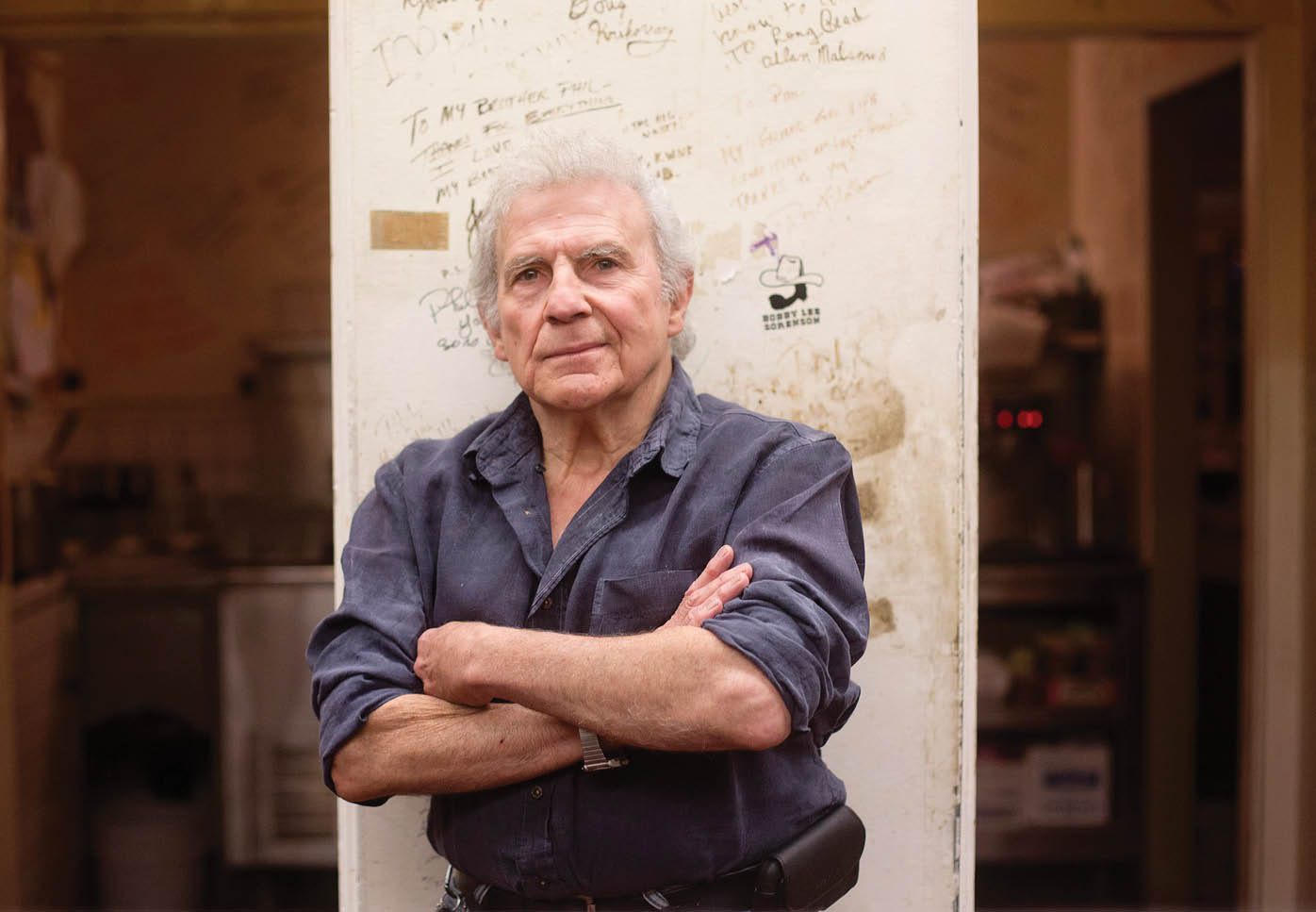 Restauranteur Phil Trani poses for a photograph inside the kitchen of his restaurant where the walls are filled with messages from sports stars throughout the years.   ///ADDITIONAL INFO: lbr.krikorian-trani.0615.dak 06/13/14 - Photo by DREW A. KELLEY, CONTRIBUTING PHOTOGRAPHER