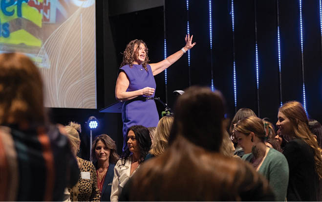 A woman in a purple dress stands on a stage, raising her hand. AI generated content