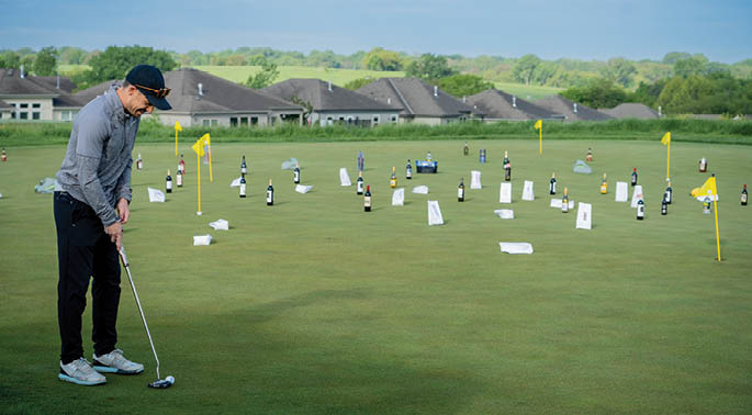 A man is playing golf on a green course, surrounded by numerous bottles. AI generated content