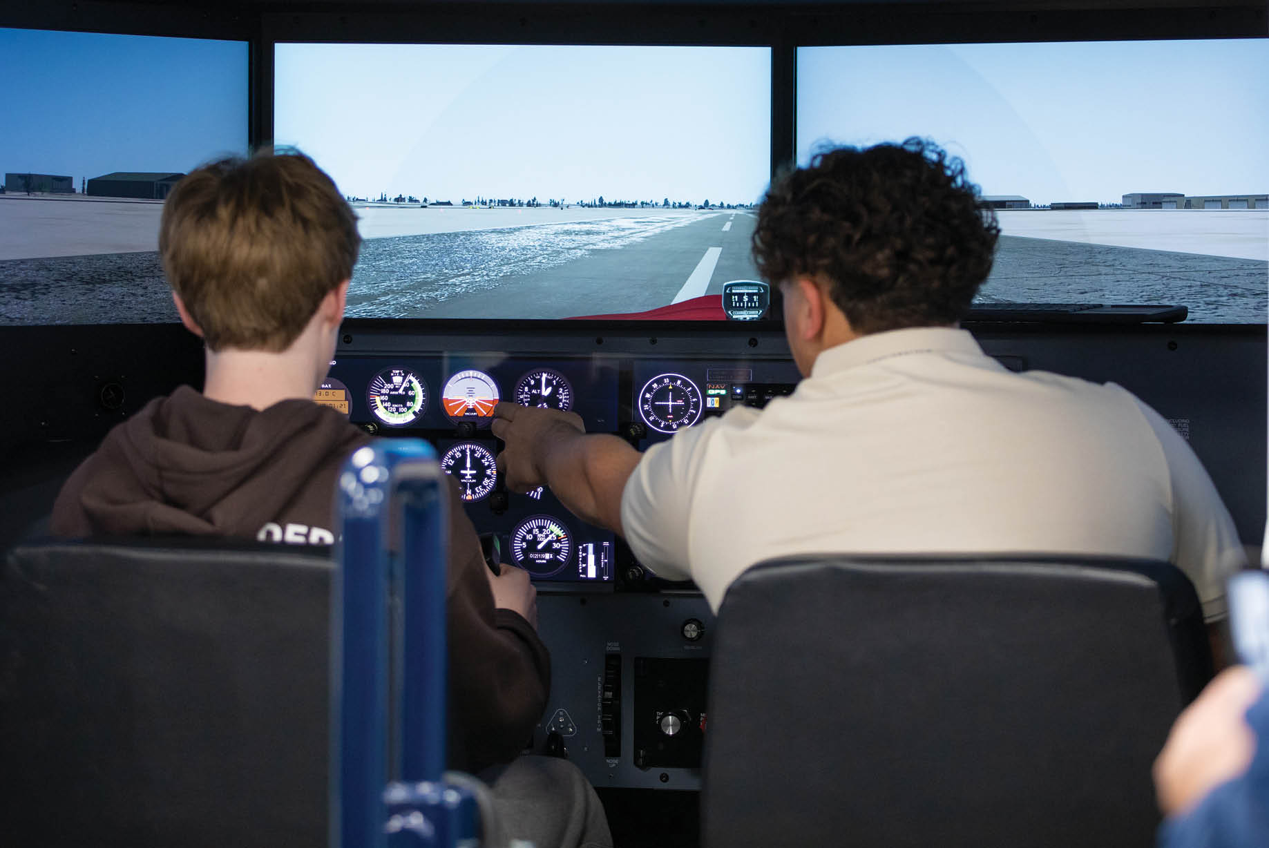 Two men are playing a racing game on a large screen. AI generated content