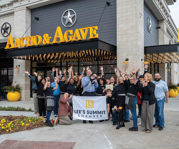 A group of people are standing outside of a restaurant, waving and smiling. AI generated content