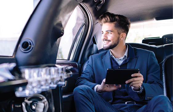 Young businessman sitting in limousine