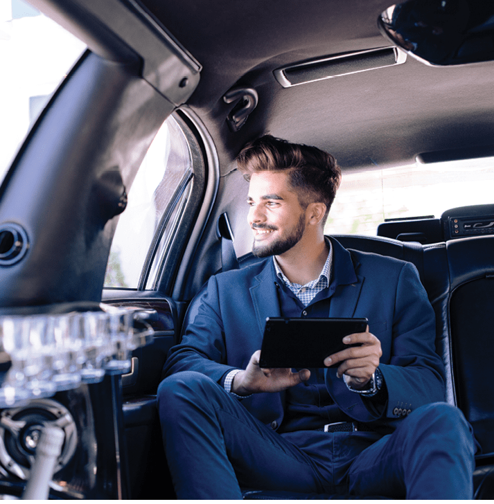 Young businessman sitting in limousine