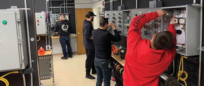 Four men are working on electrical equipment in a room. AI generated content