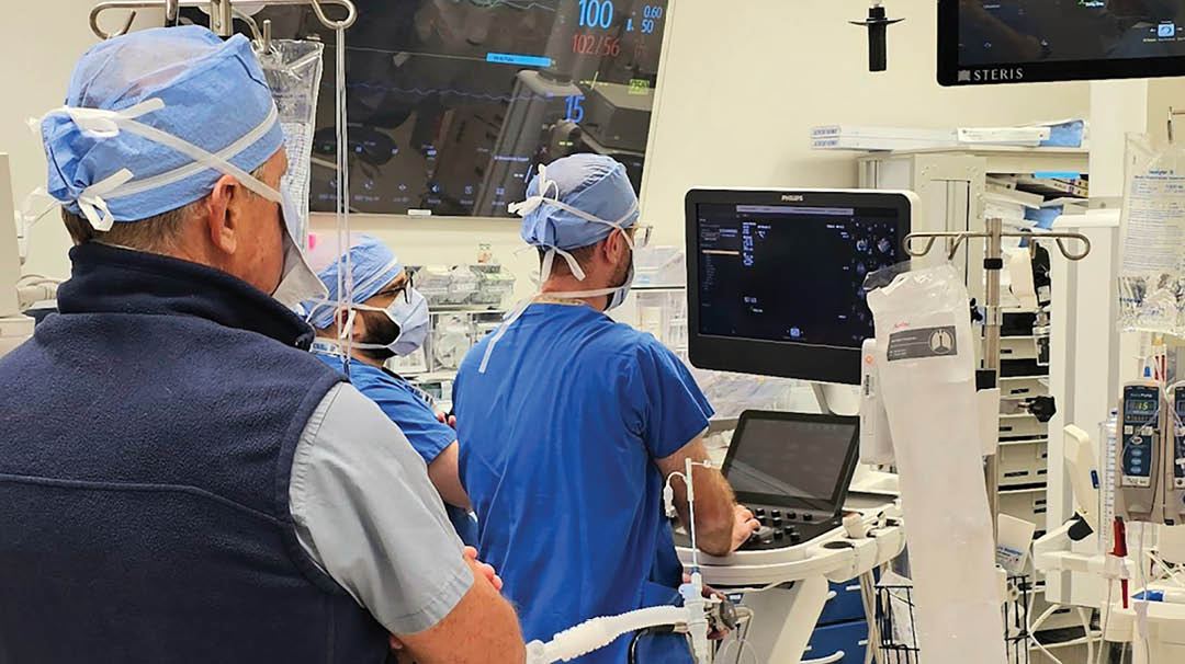 Three doctors in blue scrubs are working in a hospital room. One of them is using a laptop. AI generated content