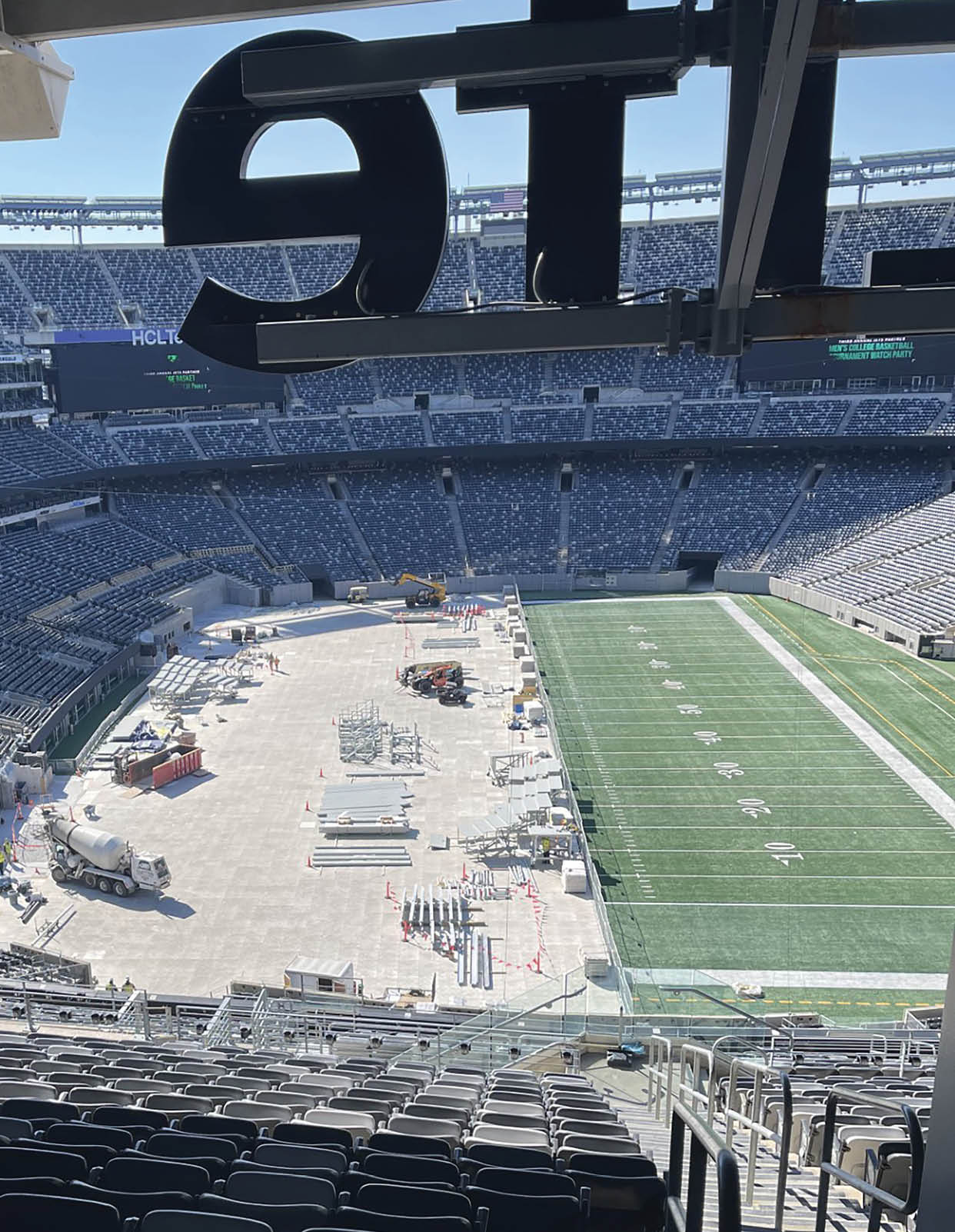A stadium with a large field and a scoreboard. AI generated content